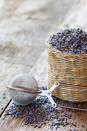 Lavender herbal tea in basket and tea infuser. Stock Photo