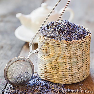 Lavender herbal tea in basket, tea infuser and teapot Stock Photo