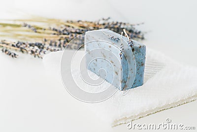Lavender soap, white cotton towel, dry lavenders close up on white background, copy space for product display. Stock Photo