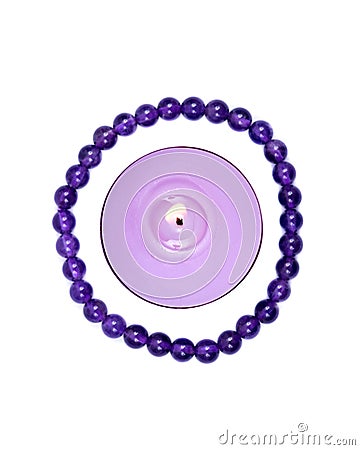 Lavender tea light candle surrounded by royal purple amethyst bead bracelet Stock Photo