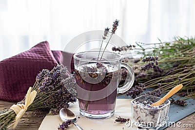 Lavender tea rustic on wood in a glass teacup. Stock Photo