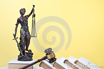 Law concept - Open law book, Judge's gavel, scales, Themis statue on table in a courtroom or law enforcement office. Stock Photo