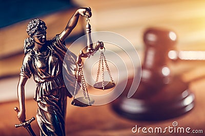 Law concept - Themis statue, judge hammer and books Stock Photo