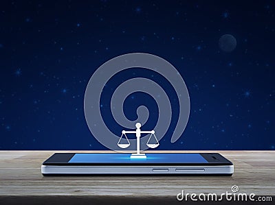 Law flat icon on modern smart mobile phone screen on wooden table over fantasy night sky and moon, Business legal service online Stock Photo