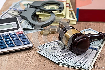 Law gavel with handcuffs, dollars and books Stock Photo