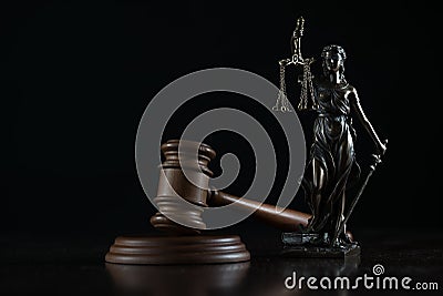 Law and Justice concept image, Lady Justice and gavel on rustic books background Stock Photo