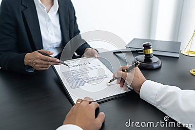 Law,libra scale and hammer on the table, 2 men are dealing and signing contract, law matters determination Stock Photo