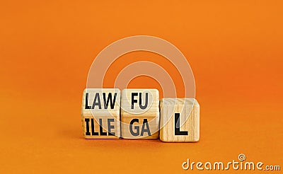 Lawful or illegal symbol. Concept word Lawful or Illegal on wooden cubes. Beautiful orange table orange background. Business Stock Photo