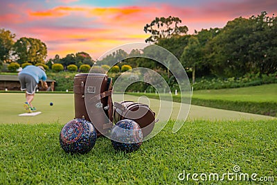 Lawn bowls leather bags and balls on the field side Stock Photo