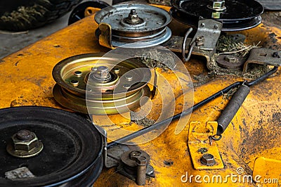 Lawn mower deck and new idler pulley. Lawn equipment maintenance repair Stock Photo