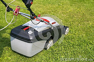 Lawn-mower electric on green grass Stock Photo