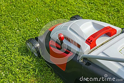 Lawn-mower electric on green grass Stock Photo