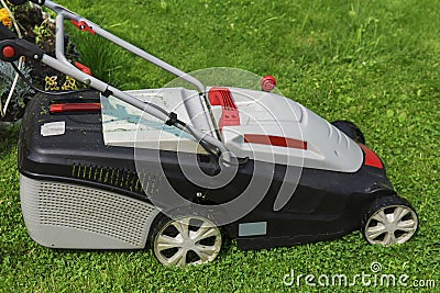 lawn-mower electric on green grass Stock Photo