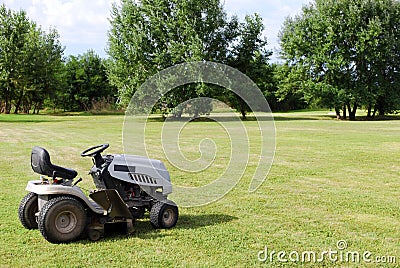 Lawn mower on field Stock Photo