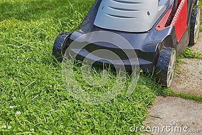 Lawn-mower on green grass Stock Photo