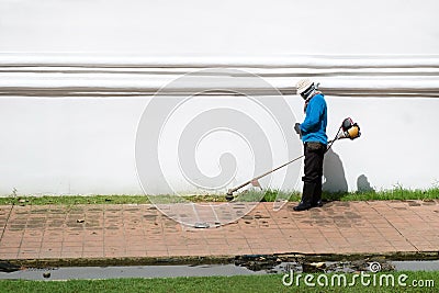 Lawn mower worker man cutting grass Editorial Stock Photo