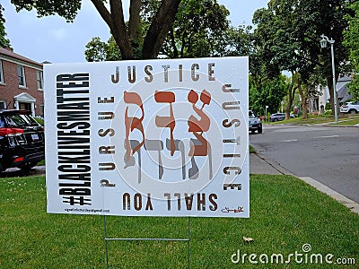 Lawn sign with Hebrew biblical quote about pursuing justice, Jewish support for Black Lives Matter Editorial Stock Photo