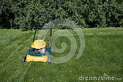 Lawnmower mowing grass with space for copy Stock Photo