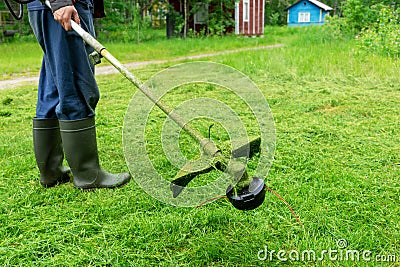 Lawnmower. Worker, a man holding a lawn mower. Landscape gardening work. Stock Photo