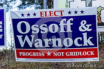 LAWRENCEVILLE, UNITED STATES - Dec 22, 2020: Georgia Senate runoff election signs along the side of the road near a polling Editorial Stock Photo