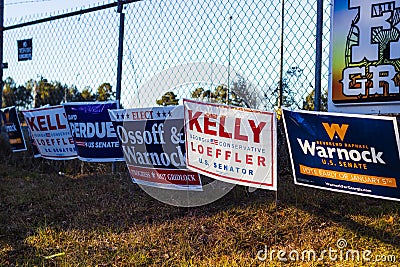 LAWRENCEVILLE, UNITED STATES - Dec 22, 2020: Georgia Senate runoff election signs along the side of the road near a polling Editorial Stock Photo