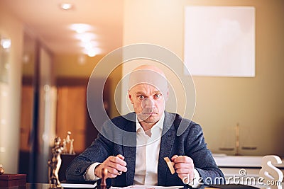 Lawyer or attorney working in the office. He prepares and signs documents for clients. Stock Photo