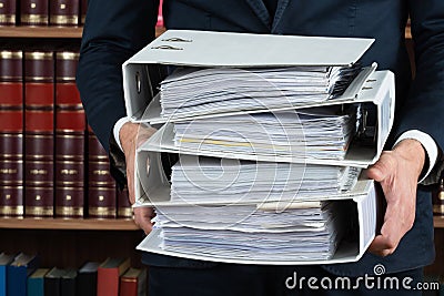 Lawyer Carrying Stack Of Ring Binders Stock Photo