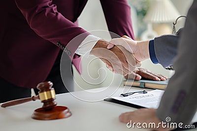 Lawyer and client shake hands, after winning a lawsuit where a lawyer hired by a client in a fraud case and proceeding in a fair Stock Photo