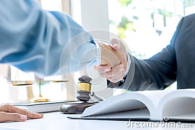 Lawyer or judge with gavel and balance handshake Stock Photo