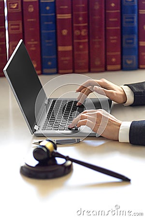 Lawyer woman`s hands with judicial gavel during online consultation with client. Stock Photo