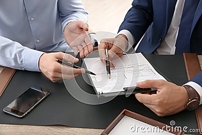 Lawyer working with client at table in office Stock Photo