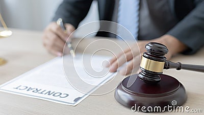 Lawyers or judges sign documents in accordance with legal and fair terms of agreement Stock Photo