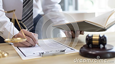 Lawyers or judges sign documents in accordance with legal and fair terms of agreement Stock Photo