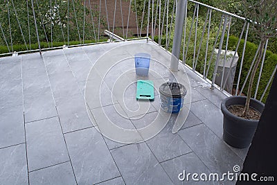 Lay tiles on the floor of a balcony and grout Stock Photo