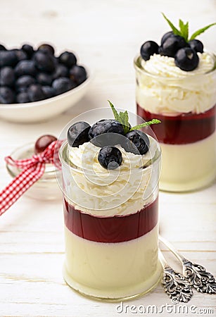 Layered blueberry dessert - panna cotta with berry jelly and blueberries. Stock Photo