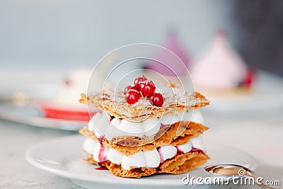 Layered cream dessert Millefeuille with vanilla cream and red berries Stock Photo