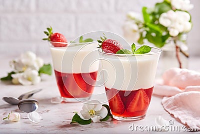 Layered dessert in glass with vanilla panna cotta and jelly with strawberries Stock Photo
