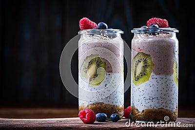 Layered healthy diet dessert in jar with fresh fruits Stock Photo