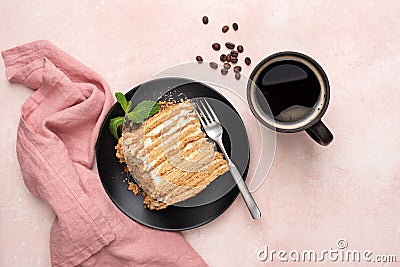 Layered honey caramel cake Medovik and cup of black coffee Stock Photo