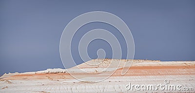 Layered multi-colored hills and slopes with relief from water and wind Stock Photo
