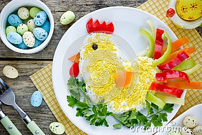 Layered vegetable egg salad in shape Easter chicken Stock Photo