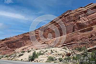Layers of Entrada and Navajo sandstone lining the road in Arches National Park in Moab, Utah Stock Photo