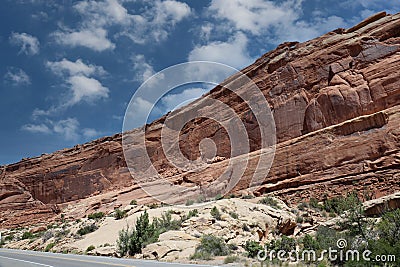 Layers of Entrada and Navajo sandstone lining the road in Arches National Park in Moab, Utah Stock Photo