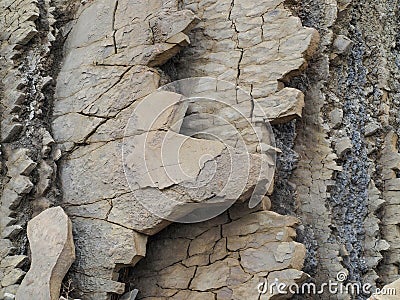 Layers of rock and sediment on the coastal rock Stock Photo