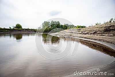 Layers of sand on the beach formed by waves and tides, layers of white sand on the shore along the river Tara. Stock Photo