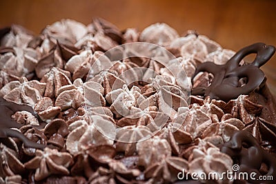 Layers of varigated frosting on top of a thin single layer coffee flavored cake on a platter set on a table in a kitchen Stock Photo