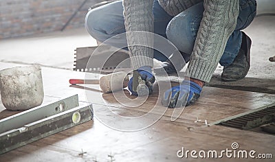 Laying floor ceramic tile. Renovating the floor Stock Photo