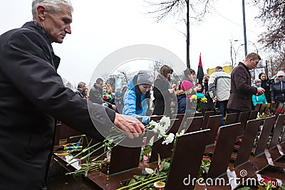 Laying flowers at the memorial cross in the Alley of Heroes Editorial Stock Photo