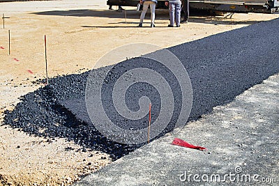 Laying fresh asphalt on the road Stock Photo