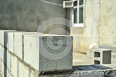 Laying gray cinder block on cement mortar, building walls and buildings Stock Photo